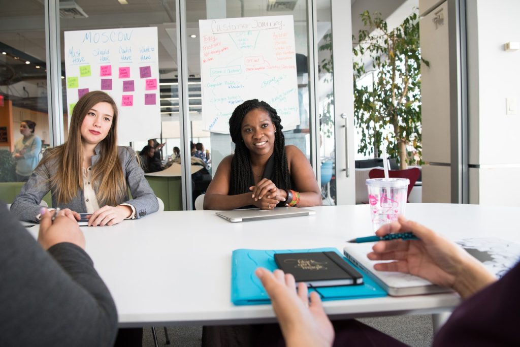 two women sitting in a meeting