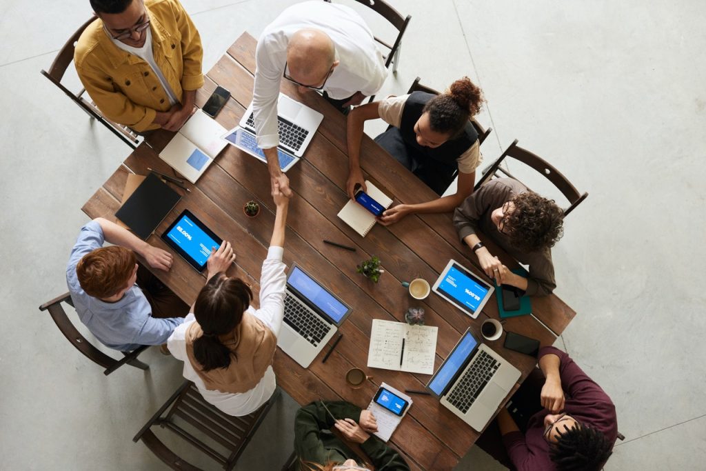 A group of people working with laptops and tablets